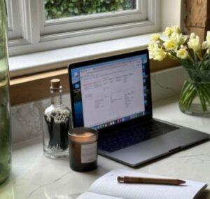 Laptop sitting on kitchen counter by window 